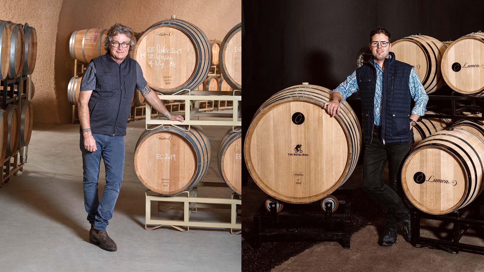 Winemakers standing in front of barrels