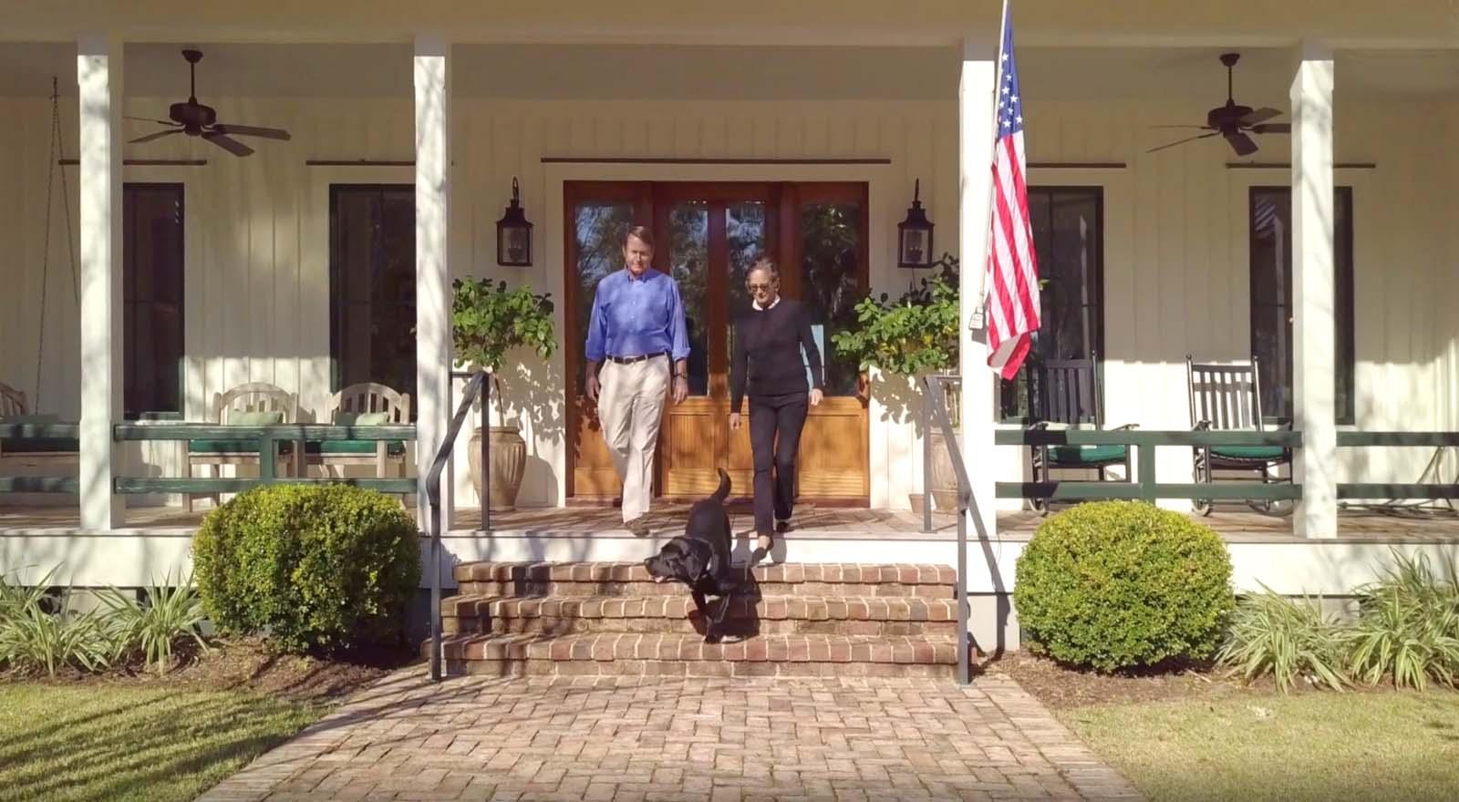 Porch with couple and dog